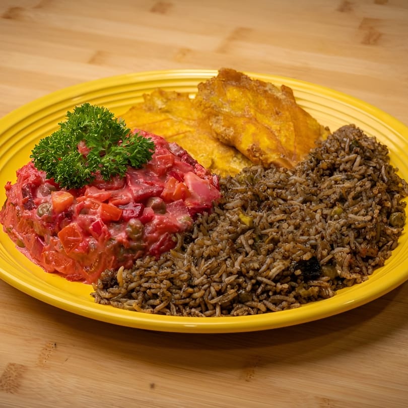 Vegan meal with red salad, fried plantains, and rice on a yellow plate.